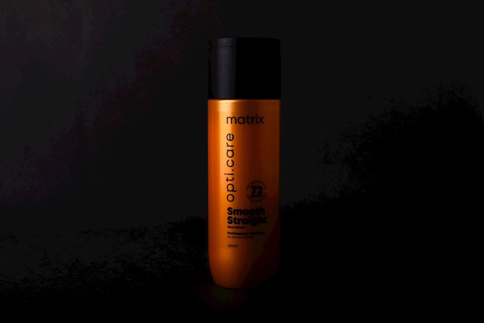 a bottle of shampoo on a black background